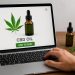CBD products and digital shopping cart illustrating online CBD purchasing in the UK
