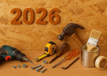 Essential DIY home repair tools and materials arranged on a wooden workbench for homeowners