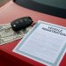 Car registration document and keys on a desk illustrating fast vehicle registration loans