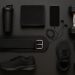 Assorted gym accessories including water bottle, resistance bands, towel, and gym bag on workout mat